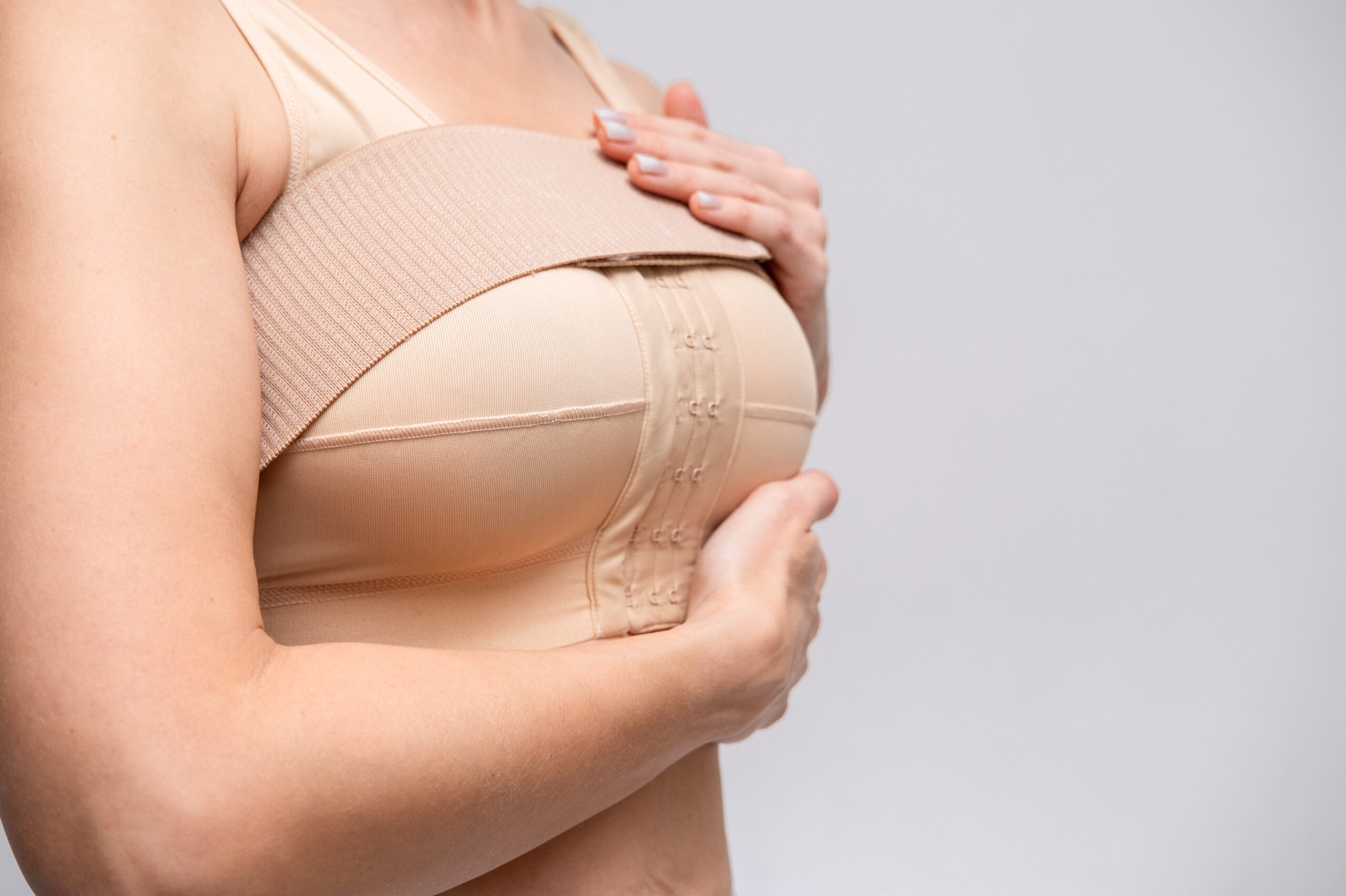 Woman recovering after breast augmentation surgery in Singapore